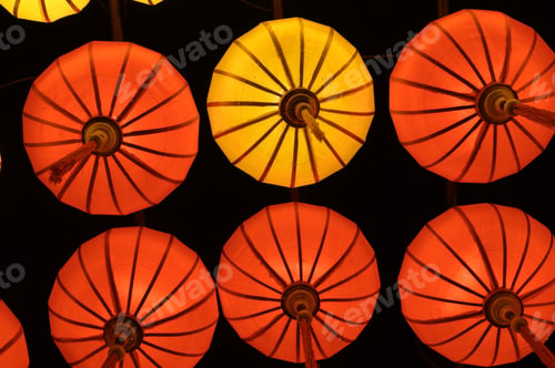 Preview: Low angle of red and orange sky lanterns flying up at night in Vietnam