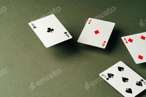 Preview: Playing cards on green background studio shot