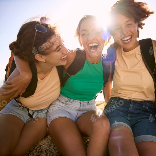 Preview: Portrait Of Female Friends With Backpacks On Vacation Taking A Break On Hike Through Countryside