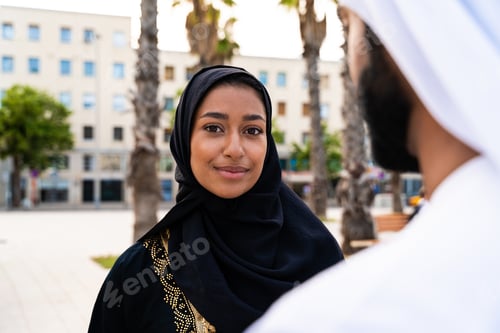 Preview: Traditional arab couple wearing emirati clothing dating outdoors
