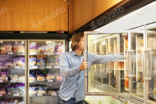 Preview: Man Choosing Frozen Food From A Supermarket Freezer