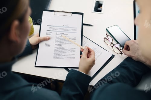Preview: Business Colleagues Examining CV Of Candidate