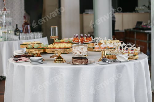 Preview: Candy bar. Table with sweets, candies, and dessert. Wedding event.
