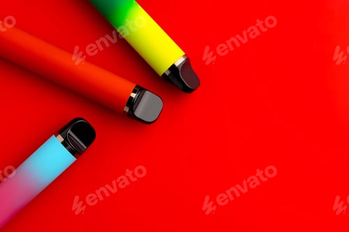 Preview: Disposable electronic cigarettes on red background close up