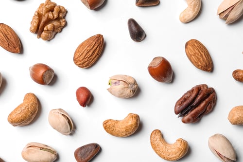 Preview: Composition with organic mixed nuts on white background, top view