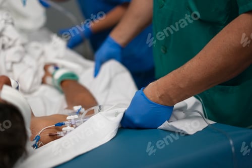 Preview: Medical team providing care to patient in hospital bed