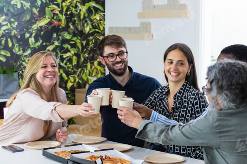 Preview: Diverse colleagues having lunch together in kitchen of office