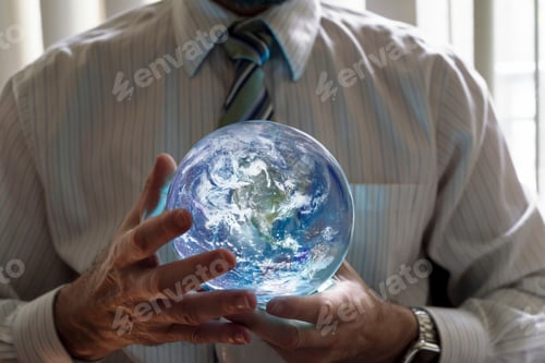 Preview: Business person holding an illuminated planet earth in the palms of both hands.
