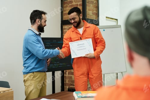 Preview: Middle Aged Man Congratulating Inmate Receiving Certificate
