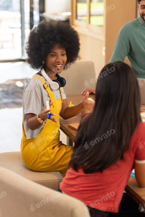 Preview: Start up business, Discussing ideas, young friends collaborating on project at table with laptop