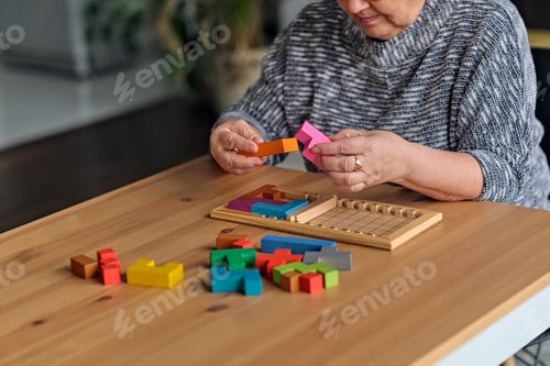 Preview: Activity can improve brain function. Elderly woman sitting at table