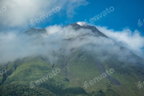 Preview: Mountain covered in a cloud of fog under the clear blue sky