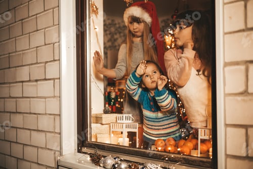 Preview: little children waiting for santa claus look out the window