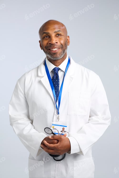 Preview: Studio Portrait Of Mature Doctor Wearing White Coat With Stethoscope And Lanyard