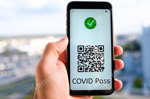 Preview: Covid pass with QR code on the screen in smartphone in mans hand on the background of cityscape