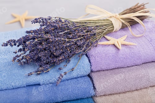 Preview: Stack of colorful bath towels on light background.