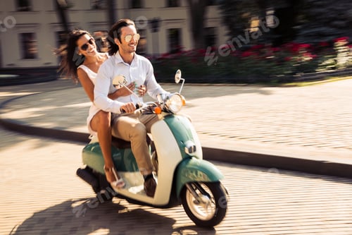 Preview: Cheerful Young Couple Riding A Scooter In Town With Fun