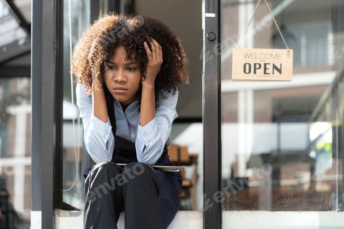Preview: black woman waiter of street cafe is waiting for clients, customersm she is bored, no people in