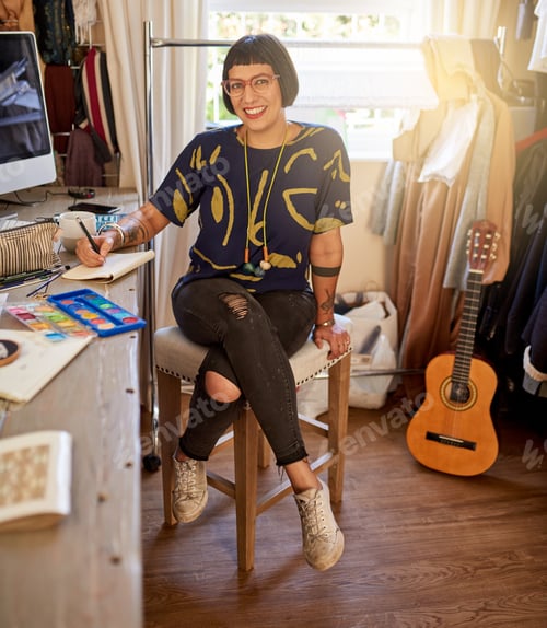 Preview: I do my best work in here. Portrait of a stylish young designer sitting in her eclectic studio.