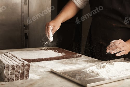Preview: Black man chief pours sugar powder on chocolate cakes