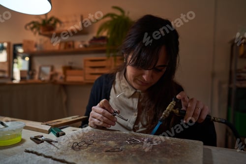 Preview: Female artisan with gas burner making handmade accessory