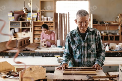 Preview: Pensive Carpenter Looking at Wooden Pieces