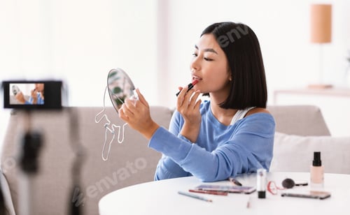 Preview: Asian Woman Recording Her Beauty Blog, Putting Red Lipstick