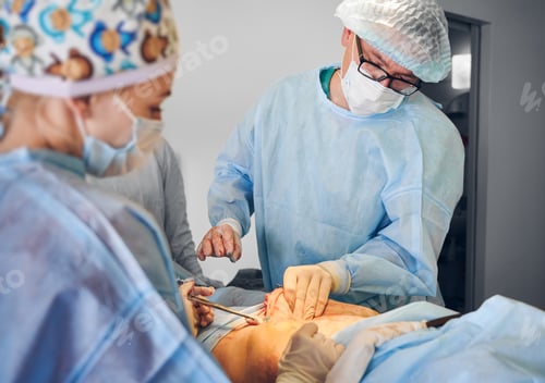 Preview: Medical workers doing abdominoplasty or tummy tuck surgery in clinic.