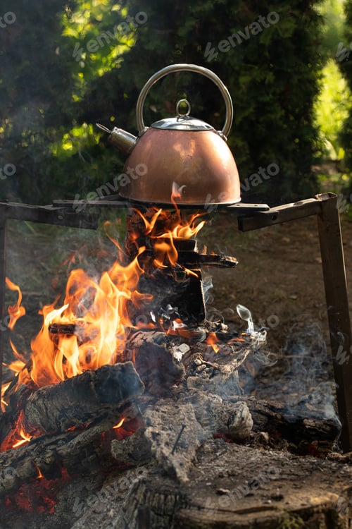 Preview: Warm water in a kettle on a campfire in nature.