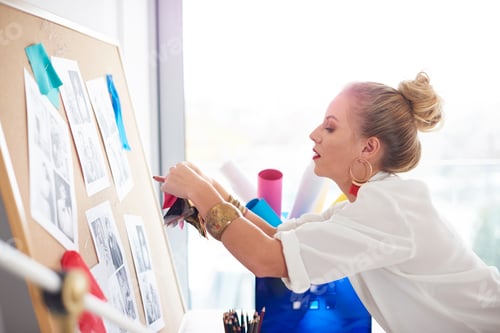 Preview: Woman hanging fabric pattern to the board