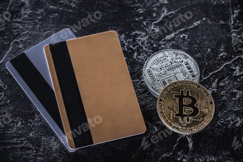 Preview: top view of credit cards and bitcoins on dark marble surface