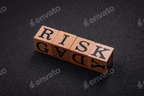 Preview: The inscription risk with wooden cubes on a dark concrete background