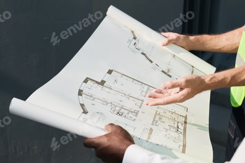 Preview: Workers Discussing Construction Plans