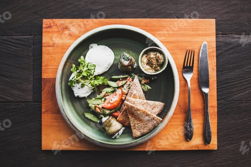 Preview: Eastern breakfast with poached eggs, tomatoes, couscous, eggplant and spicy sauce