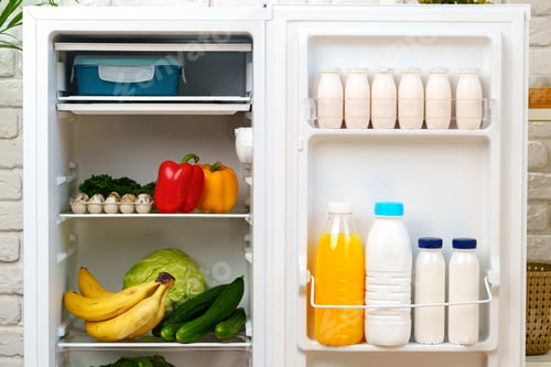 Preview: White Milk Bottles Stored in a Refrigerator Door Shelf