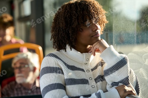 Preview: African american woman traveling on bus daydreaming