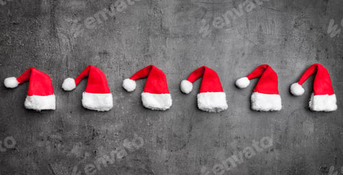 Preview: Christmas Santa hats on rustic background with copy space