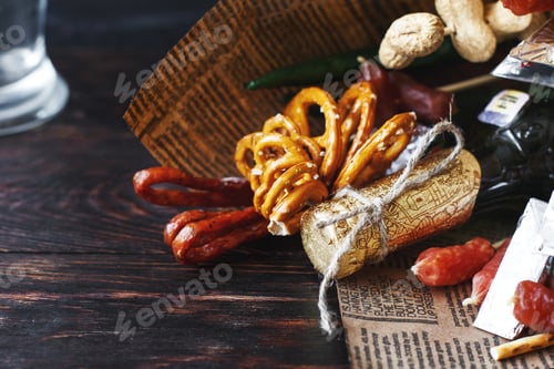 Preview: a can of beer with a snack on a wooden dark background . gift bouquet to a man