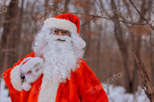Preview: On cold winter day in a red Santa hat walk in a beautiful snowy forest, carry Christmas present gift