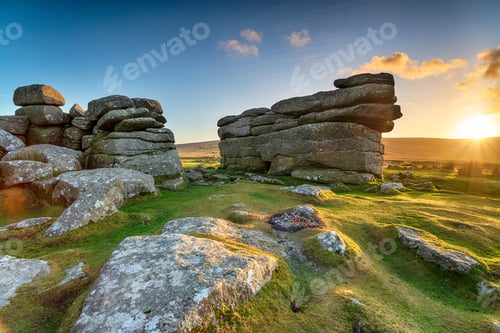 Preview: Beautiful sunset over granite rock formations at Combestone Tor