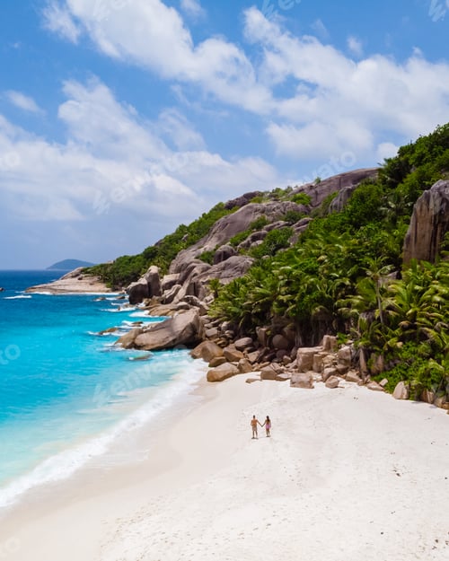 Preview: Couple men and woman walking at a tropical beach, Drone view from above Seychelles Cocos Island