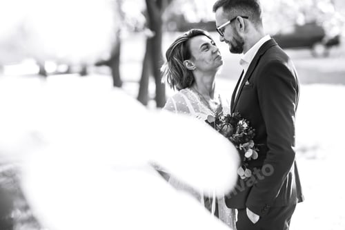 Preview: Beautiful black and white photo of bride and groom. Happy couple posing and smiling in wedding dress