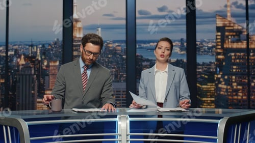 Preview: Couple hosts reporting news in multimedia channel closeup. Reporters discussing