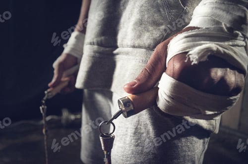 Preview: Cropped shot of a mans hands holding a skipping rope during his workout