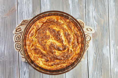 Preview: Puffed cauliflower souffle in transparent bowl on wooden background
