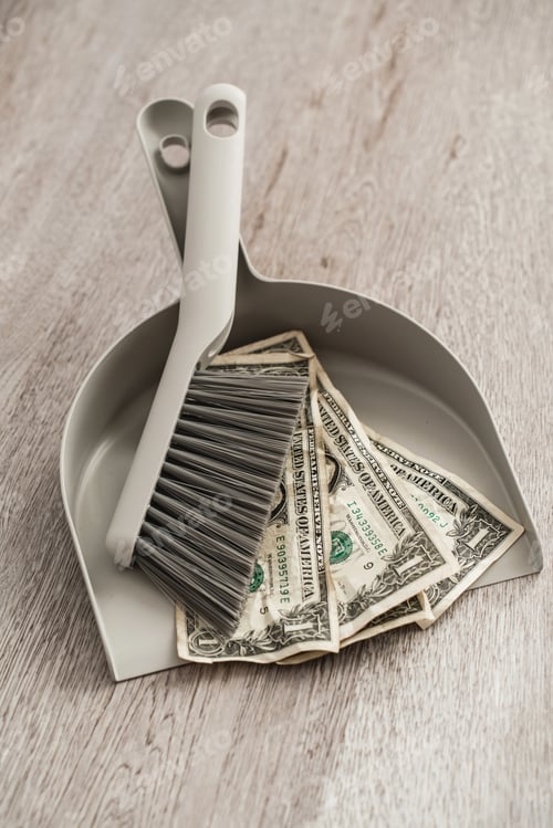 Preview: Dustpan and brush alongside scattered one-dollar bills on the floor