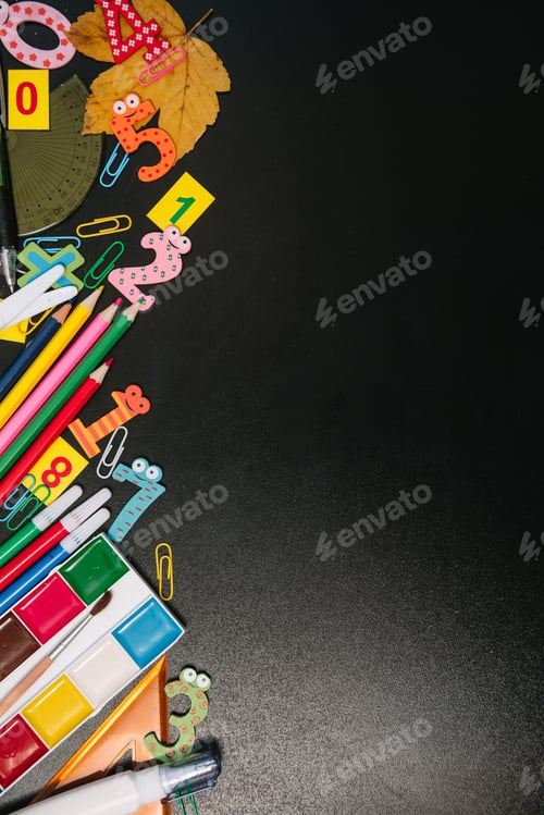 Preview: Back to school concept. School and office supplies on blackboard background.