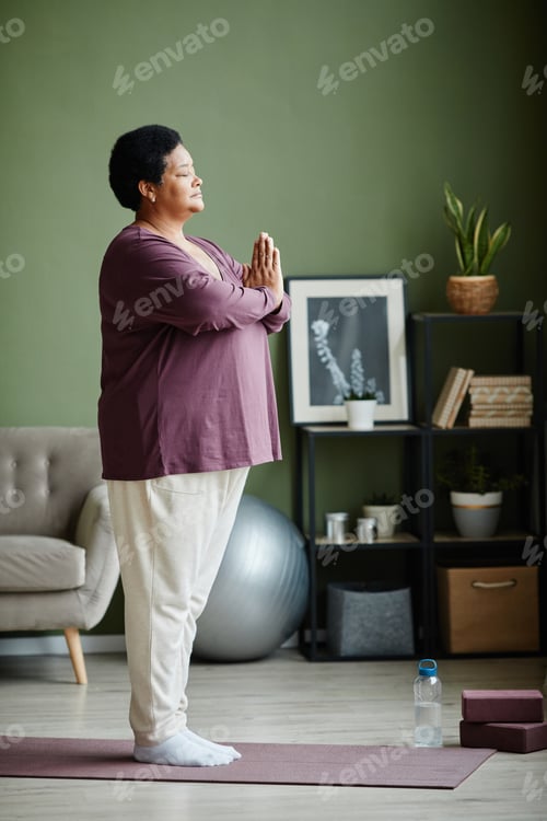 Preview: Active Senior Woman Meditating at Home
