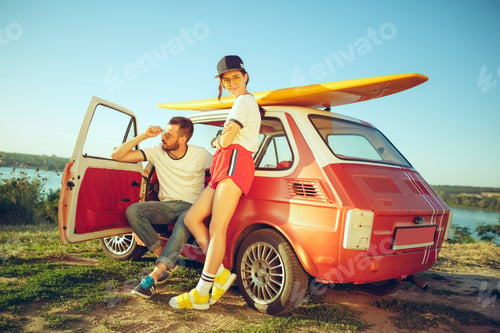 Preview: Couple resting on the beach on a summer day near river