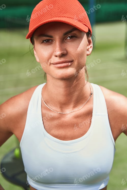 Preview: Beautiful female player posing outdoors alone and smiling